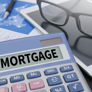 MORTGAGE Calculator  on table with Office Supplies. ipad